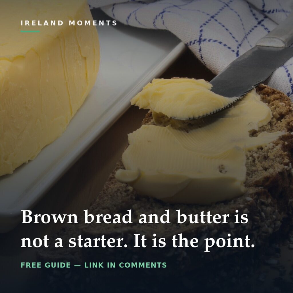 Butter being spread on sliced brown bread with a knife