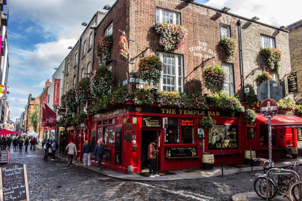The Temple Bar pub with hanging flower baskets on a cobblestone street in Dublin