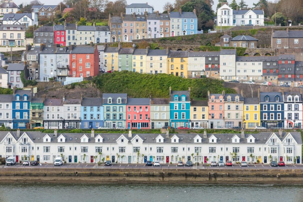 Colorful houses line a hillside town overlooking the water