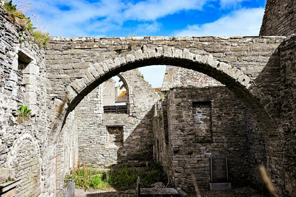 Stone ruins with an arched opening under blue sky